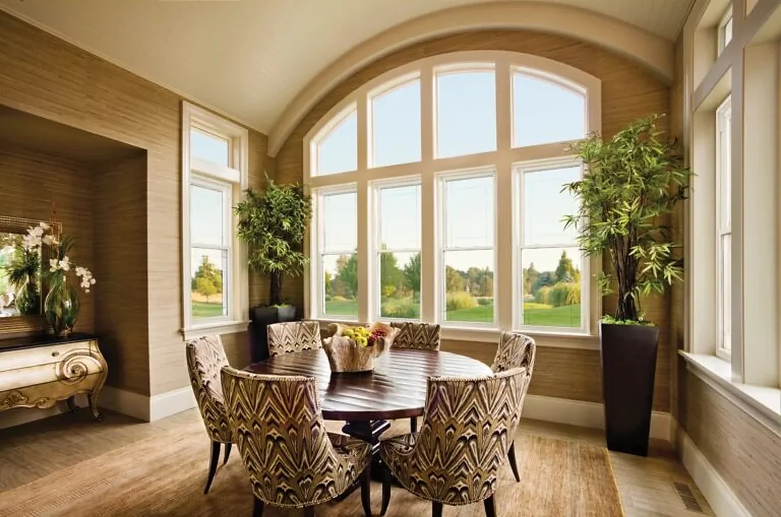Dining nook with an arched window wall and double hung windows