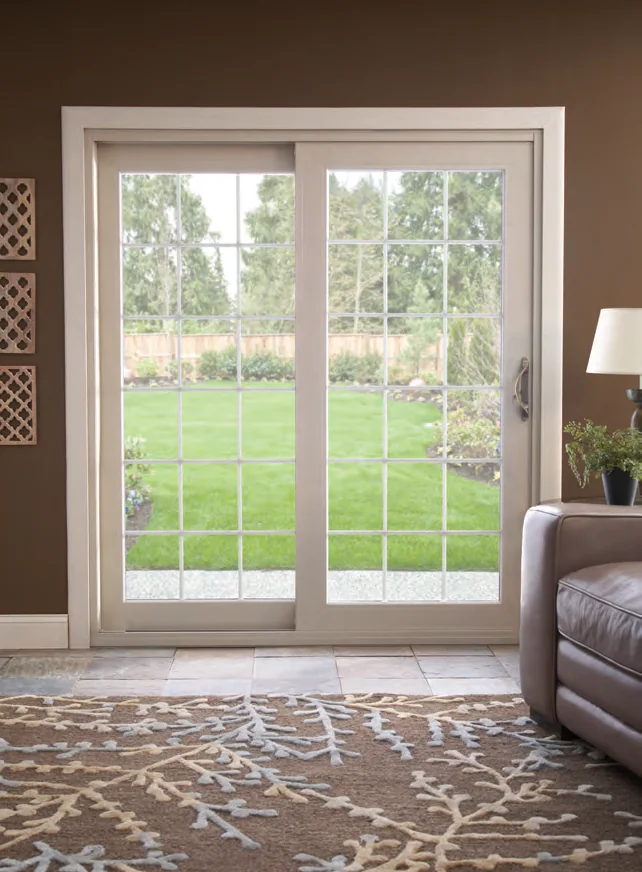 Classic white sliding patio door opening onto a green lawn